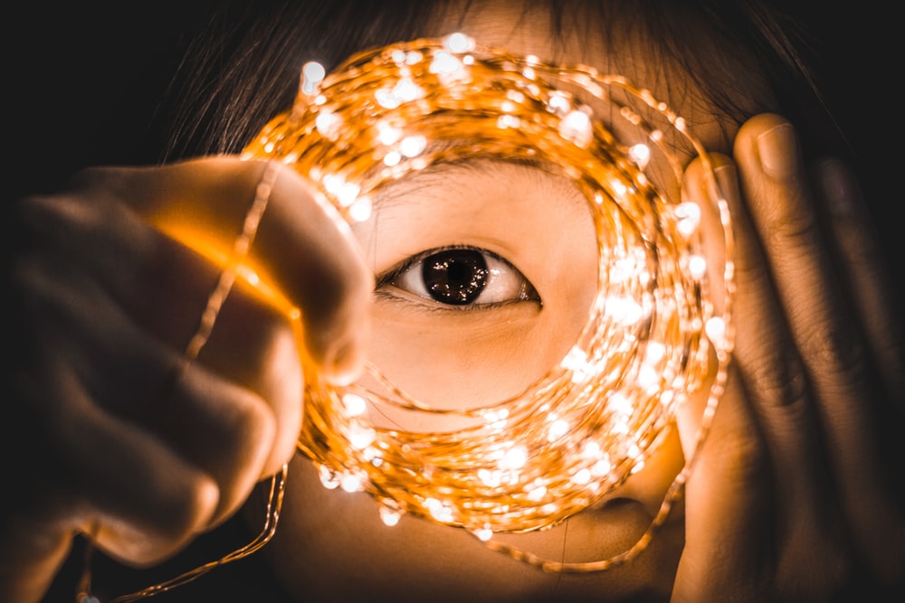 Start Now - eye through circle of fairy lights